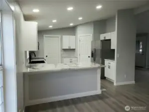Very Spacious All New Kitchen with New White Cabinets, Counter Tops with Breakfast Eating Bar Walk In Pantry, Stainless Appliances Including Microwave, New Paint, Sink, Faucet, Recessed LED Lighting, Trim and Vinyl Plank Flooring.
