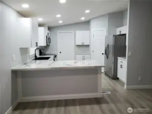 Very Spacious All New Kitchen with New White Cabinets, Counter Tops with Breakfast Eating Bar Walk In Pantry, Stainless Appliances Including Microwave, New Paint, Sink, Faucet, Recessed LED Lighting, Trim and Vinyl Plank Flooring.