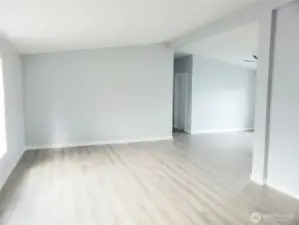 Huge Living Room with New Paint, Trim, Cathedral Ceiling and Vinyl Plank Flooring.