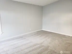 View of the Primary Master Bedroom Showing Cathedral Ceilings, All New Paint, Trim and Carpeting.