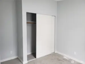 Another Picture of the Spacious Second Bedroom with New Paint, Trim and Carpeting Showing Large Closet.