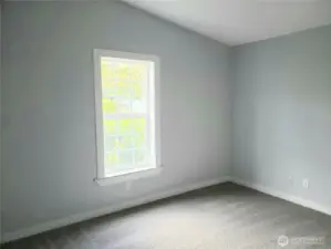 Picture of the Spacious Third Bedroom with New Paint, Trim and Carpeting.