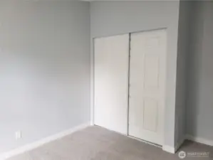 Another Picture of the Spacious Third Bedroom with New Paint, Trim and Carpeting Showing Large Closet.