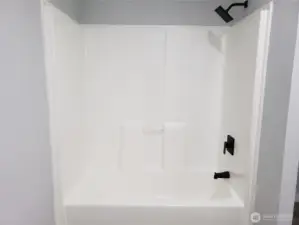 Another View of the Primary Master Bath Room Showing  New Shower Tub Combination, Paint, Trim and Vinyl Plank Flooring.