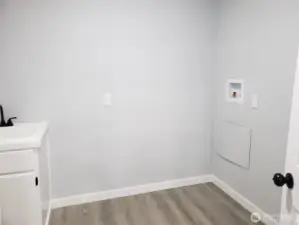 Another View of the Nice Utility Room with New Vanity, Washer and Dryer Hook Ups.