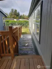Another picture showing New Covered Front Porch and Walkway to the Backyard.