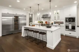 Large island has lots of room for seating, several drawers and cabinets for storage, and a built-in ice maker.