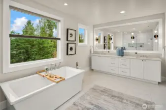Large primary bathroom with double sinks, oversized soaking tub, and heated floors.