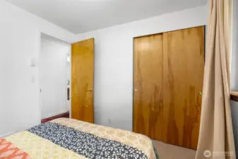 Second bedroom featuring sliding closet doors and flexible furniture placement.