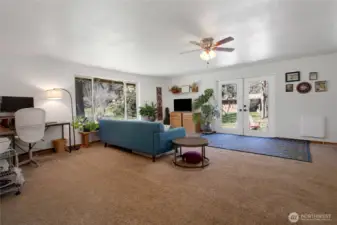 Large family with french doors that lead to a tranquil river rock patio