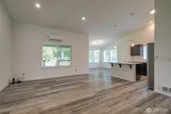 Entering the home via the front door, you step into the open concept living space of the great room, kitchen, and dining room.
