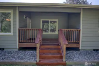 The deck leads down into the fully fenced back yard.