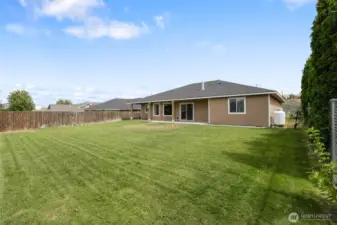 Backyard is grassed with underground sprinklers