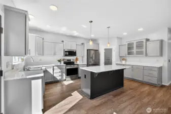 Updated kitchen with quartz countertops, high-end appliances & walk-in pantry
