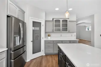 Abundant cabinet storage and new high-end appliances. View into dining area.