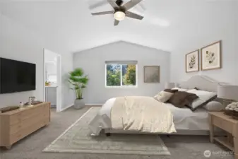 Spacious primary bedroom with vaulted ceilings, large ensuite, and backyard views. (virtually staged)
