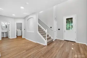 View of entrance, powder bath and laundry room.
