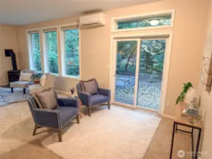 The living area is large and spacious with many windows.