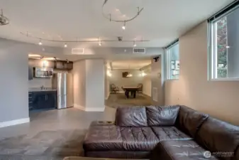 Community room with pool table, fireplace, kitchen prep area