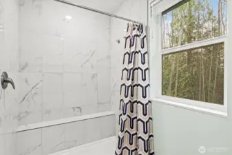 Floor-to-ceiling tile in the primary bathroom.