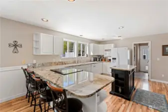 Large kitchen with lots of storage with Granite and hardwood flooring