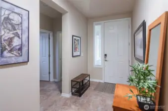 Inviting front entry Tiled floors through entry and guest bath to the left.