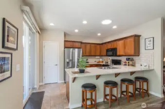Plenty of seating at the counter for casual dining.  Pantry ahead.  Notice the solar tube that allows loads of natural light.