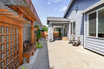 View of covered back patio.  Trellis detail, complete with sitting benches.
