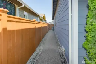 Paved walk ways on both sides of this home.  Notice the brand new quiet AC unit.