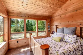 Primary bedroom overlooks the peaceful and very private 5 acres.