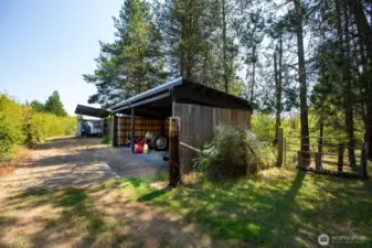 Covered shed for yard equipment.