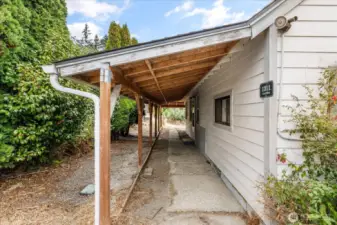 Front door is just ahead, under covered porch.