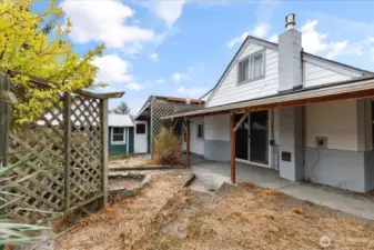 East side of home features covered porch and sliding glass doors.