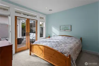 Main level bedroom suite with 3/4 bath, walk in closet. French doors open up to back patio. (Great main level primary option!)