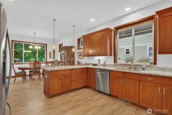Large kitchen with ample storage and counter space; stainless steel appliances remain with the home.