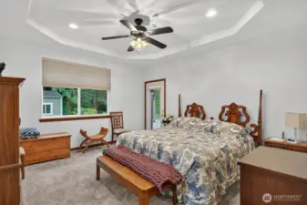 Luxurious primary bedroom suite featuring a spacious walk-in closet for optimal storage, complemented by an elegant ensuite bathroom boasting a large, inviting walk-in shower for a spa-like experience.