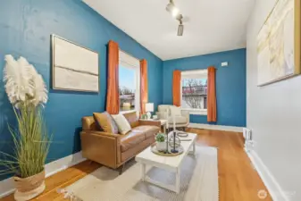 Cozy living room with high ceilings and hardwood floors
