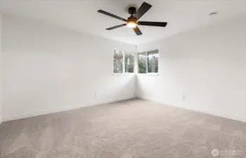 Bedroom 1 with brand new luxurious carpet and fan