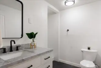 Main bath includes new vanity with marble top and new vinyl tile flooring