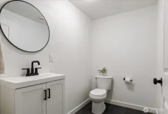 Bedroom 2's 1/2 bath has new vanity and new modern vinyl tile flooring