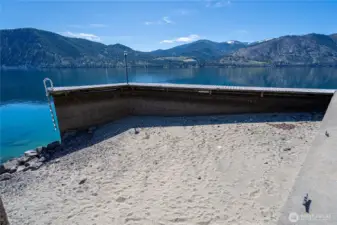 Protected Sandy Cove - photo is from low lake level. This is sandy swim area in Summer. Dock has space to tie jet skis