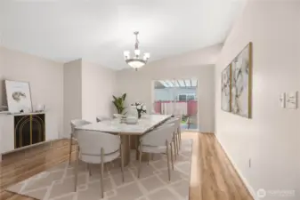 View of your dining area off the kitchen in the rear of the home, patio doors lead to your covered patio. ***Virtually Staged***