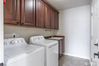 Large mudroom off of garage with storage and laundry