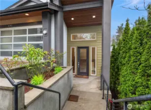 Just off the paver driveway is this formal covered entry with lovely landscaping adding a softness to the hardscape.