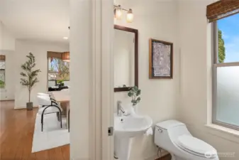 Discreetely located is this main floor powder room in addition to three more bathrooms.
