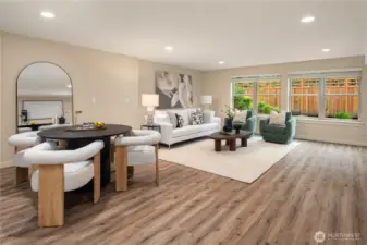 The massive rec room features a covered deck and lots of space. This level is also wired and plumbed for a second kitchen to the left.