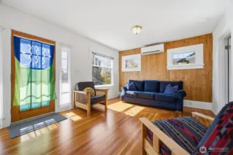 Once inside you will notice the southern sunlight streaming in on the gorgeously refinished original fir floors with the concentric rectangular pattern.