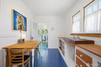 Looking across the kitchen to the laundry/back porch beyond.