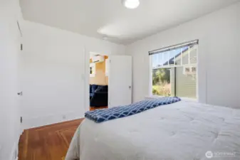 The primary bedroom has a closet to the left and looks out to the westerly side yard.