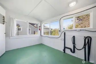Looking toward the west half of the back porch/utility room which is very spacious and could be another useful space.